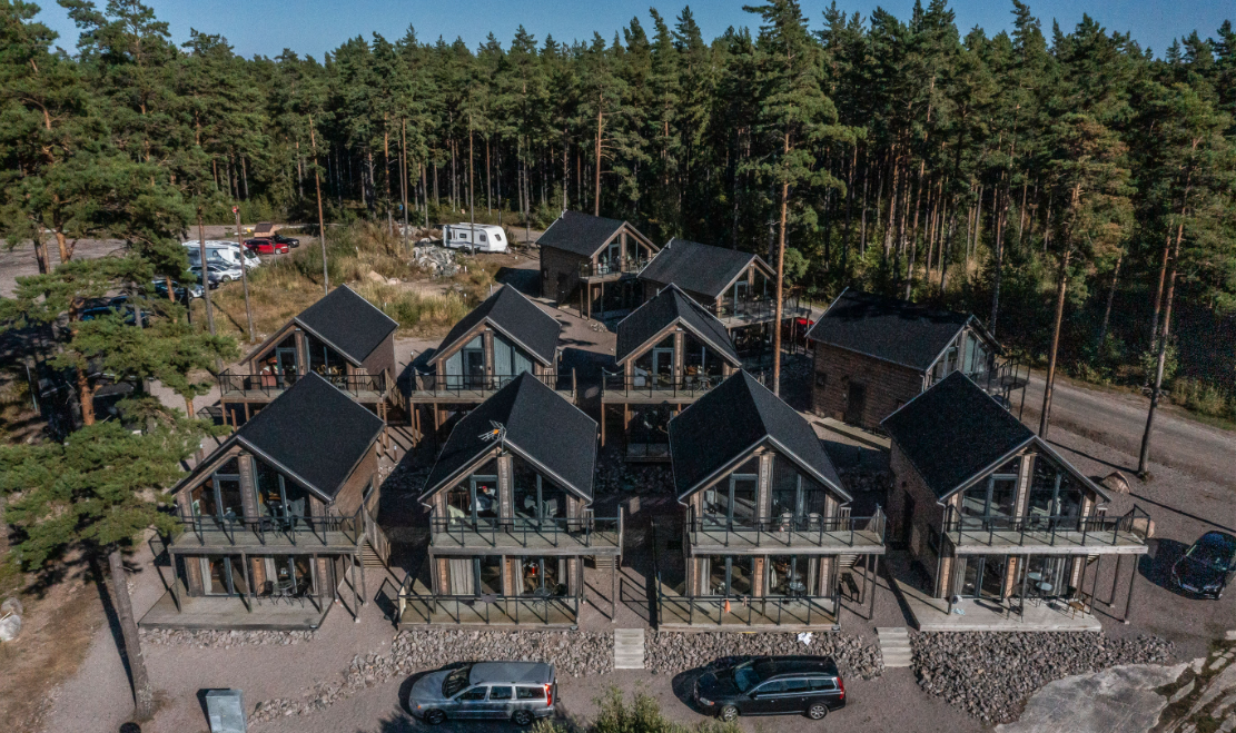 Aerial view of Laxhall's cottages in the forest by Torsö and Lake Vänern